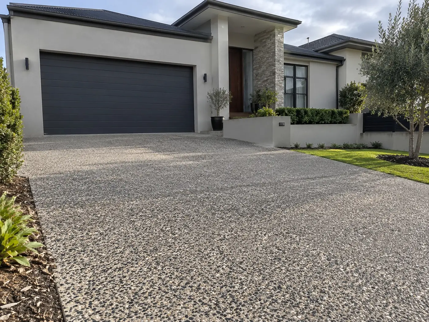 Broad exposed aggregate driveway running up to a double garage in Darwin NT